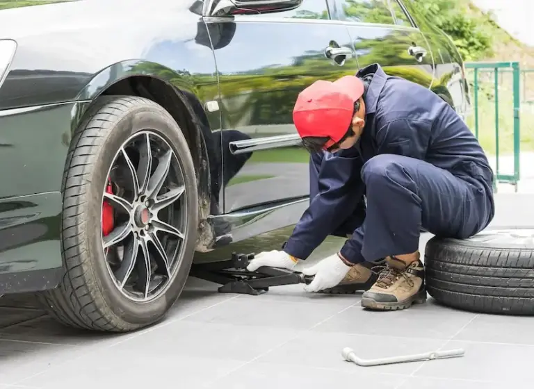 mechanic-replacing-lug-nuts-changing-tires-vehicle_1176636-4304
